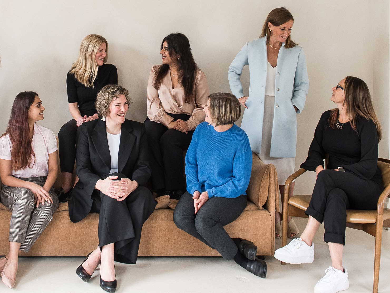 minerva bc bunch of women conversing while standing and sitting