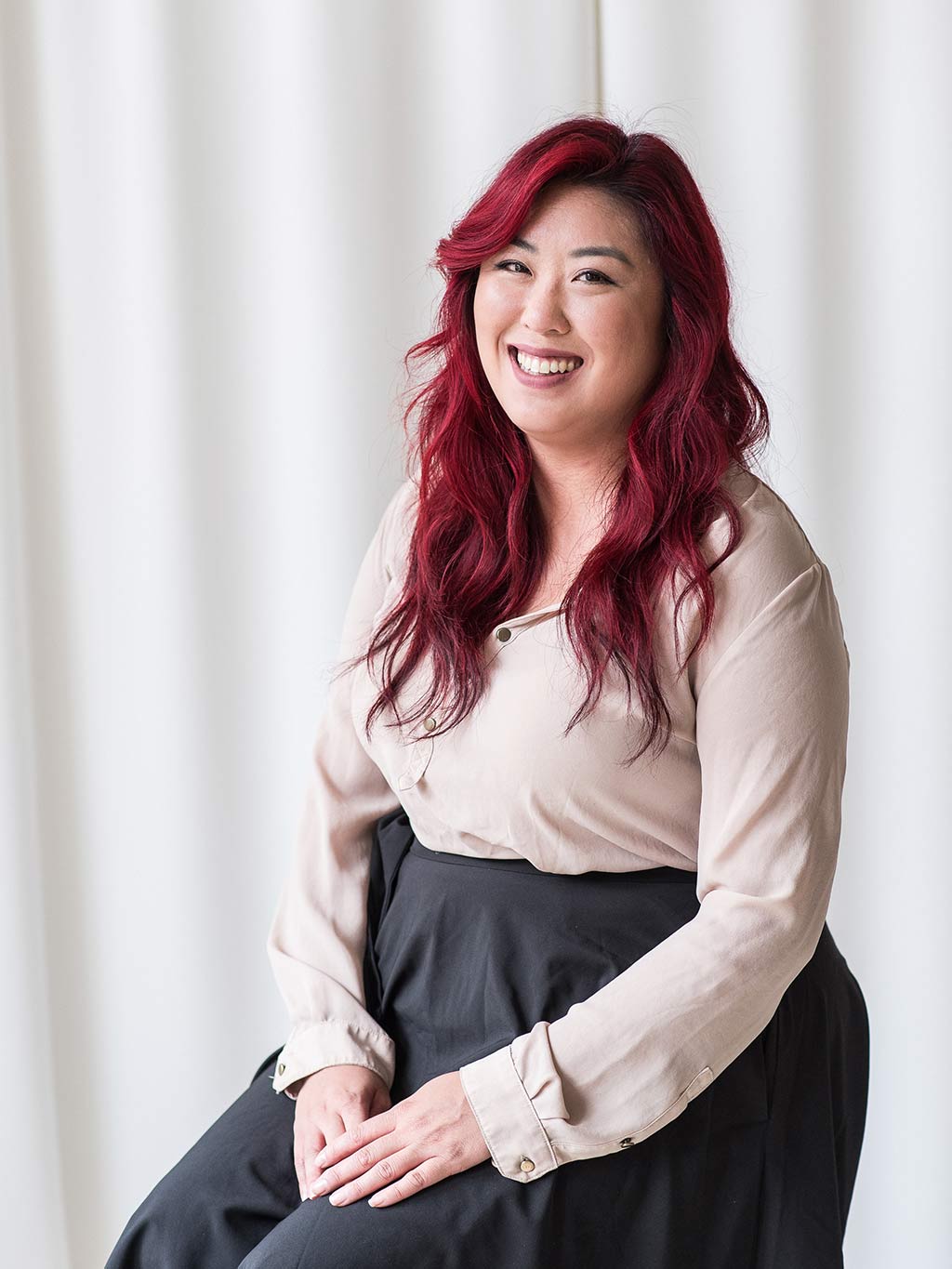 minerva bc smiling woman with red hair sitting