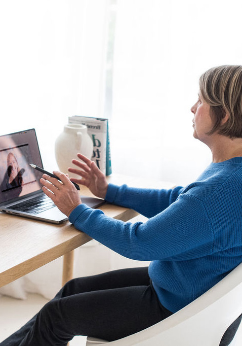minerva bc woman sitting at desk while working on laptop