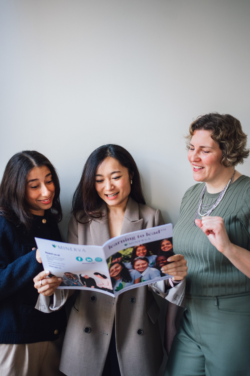 Minerva BC- 3 women reading a leadership magazine